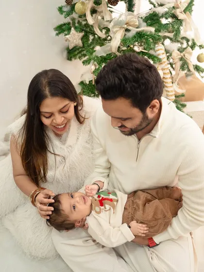 The magic of a baby's first Christmas. This cozy holiday mini-session was all about capturing the quiet cuddles and gentle smiles by the Christmas tree, creating their first festive family memory.
