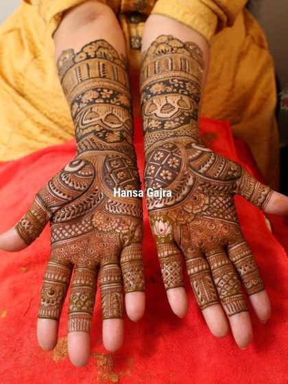 The front view of this elegant design for the mother of the bride. The patterns are dense and traditional, reflecting the importance of her blessings and her central role in the family's celebration.