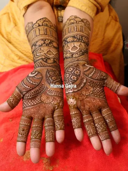 The front view of this elegant design for the mother of the bride. The patterns are dense and traditional, reflecting the importance of her blessings and her central role in the family's celebration.