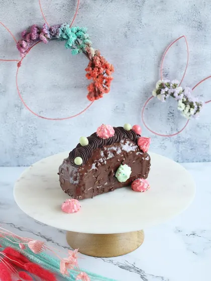A festive Easter-themed chocolate log cake, perfect for slicing and sharing with family.