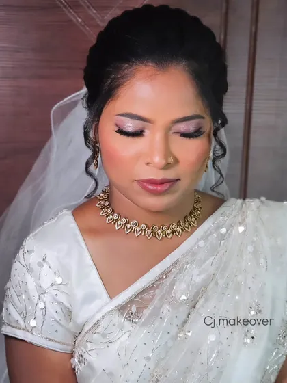 A close-up of a bride's makeup for her church wedding, featuring soft, shimmery eyes and a glossy lip.