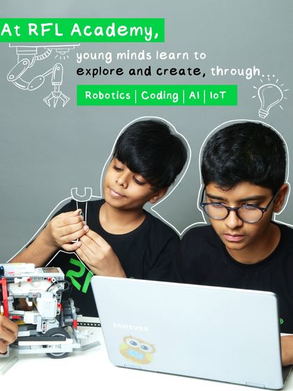 At our academy, young minds learn to explore and create through Robotics, Coding, AI, and IoT. This image shows two students collaborating, one building and one coding.
