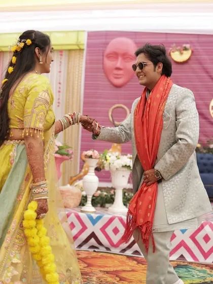 A beautiful moment between the bride and groom during their Haldi ceremony, with me in the background facilitating the event.