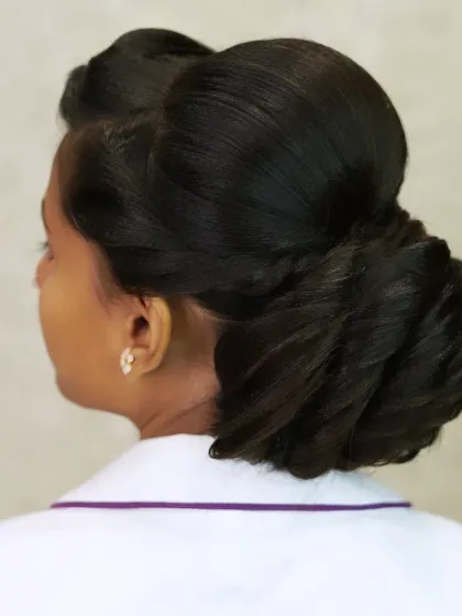 A classic and elegant side bun, a timeless hairstyle for any formal occasion.