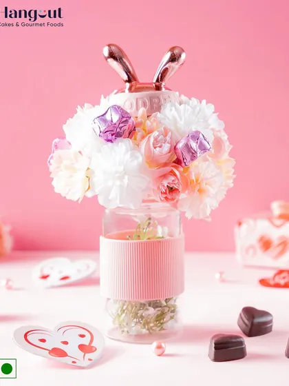 This cute Valentine's hamper features a bunny-eared sipper filled with chocolates and topped with a floral arrangement. It's a playful and charming gift for someone special.