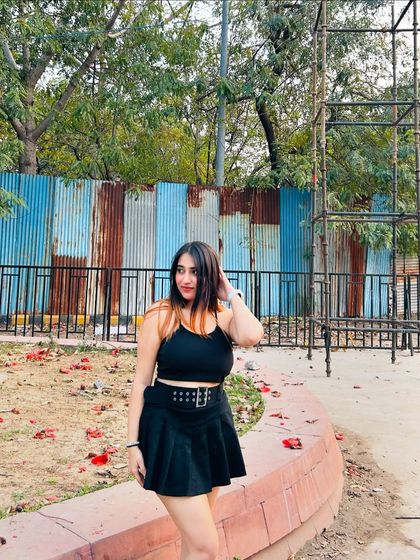 A front view of the black skater dress, styled with a chunky belt. This shows how I use accessories to add edge to a classic look.