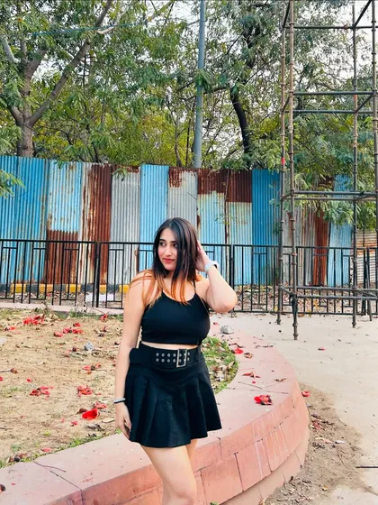 A front view of the black skater dress, styled with a chunky belt. This shows how I use accessories to add edge to a classic look.