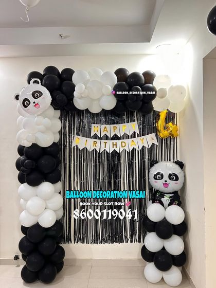 A simple panda-themed balloon arch for a home party. The black and white balloons are paired with panda foil balloons for a fun and easy setup.