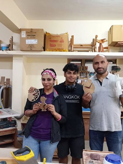 A family that builds together, stays together. Roshni, Krishna, and Wilson showing off the clocks and planter stand they made during a fun Saturday workshop.