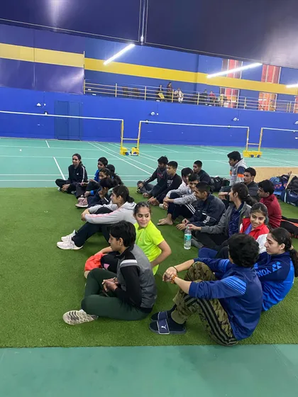 A team session on the sidelines. I believe in fostering a strong team spirit and ensuring players are mentally prepared and focused before they step onto the court.