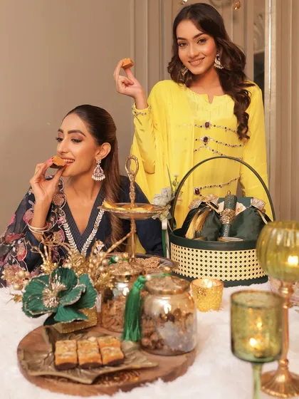 Enjoying the fruits of my labor with a friend. Our festive table is laid out with a variety of my creations, from traditional sweets to savory snacks, all ready to be shared and enjoyed.