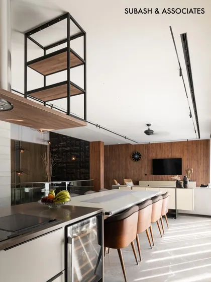 Integrating wood in the kitchen and dining area brings warmth and a touch of tradition to this contemporary modern home.