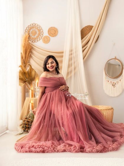 A relaxed, seated portrait in the mauve gown, creating a soft and elegant look in the boho setting.
