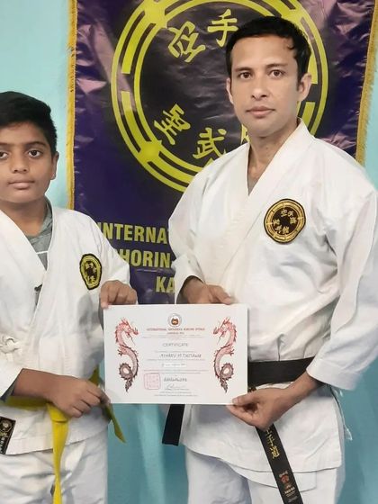 The serious expression of this student reflects the focus required during a grading. I am presenting him with his official certificate from the International Shorin-Ryu Seibukan Karate association.