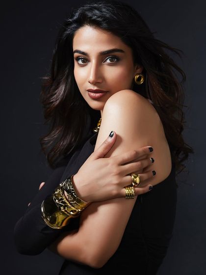 A portrait shot focusing on the contrast between the simple black dress and the chunky gold cuff and earrings. This shows my approach to accessory-driven styling.