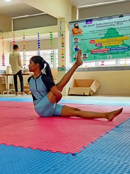 A complex seated twist performed by Deepa, part of her artistic yoga routine for the championship.