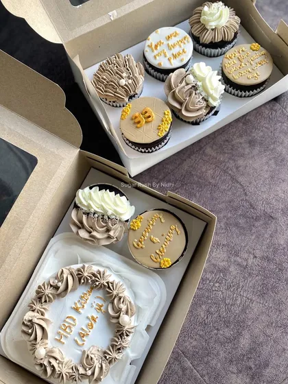 A birthday hamper featuring a custom bento cake and a box of assorted cupcakes.
