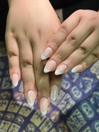 A full view of the abstract white swirl French manicure, perfect for clients from all over the world.