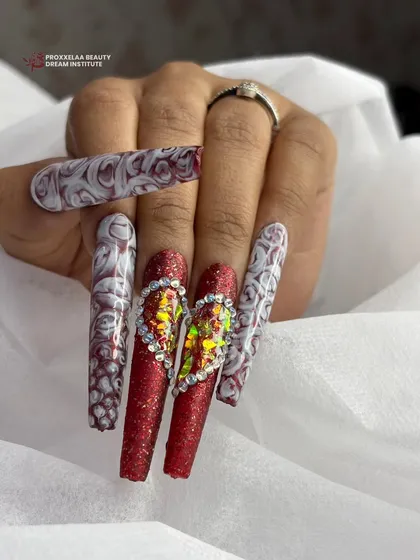 Another view of the dramatic red glitter and marble heart nails, showing the incredible detail and texture of this statement-making set.