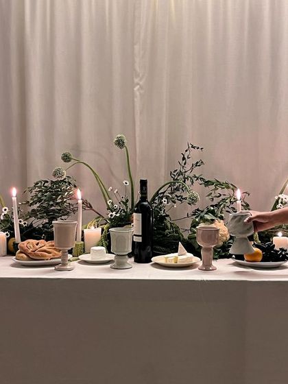 A wide shot of the beautifully styled tablescape, featuring our full collection of collaborative goblets. It's a story of passion and creativity, from an idea to the dinner table.