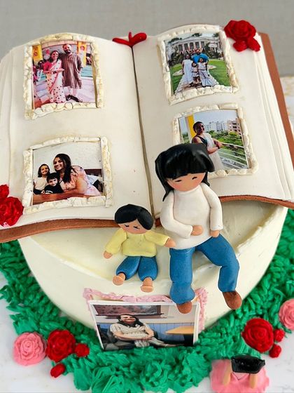 A different view of the 40th birthday storybook cake, showing the intricate details of the edible photo frames and the handcrafted fondant figures.