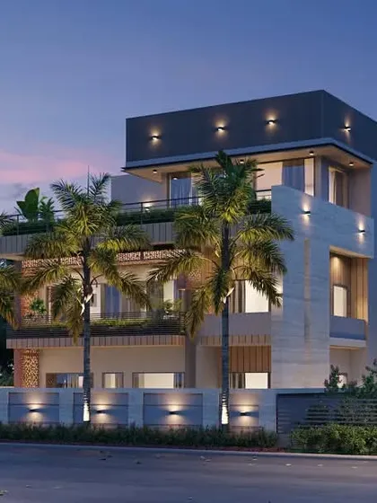 Another evening shot of the farmhouse, capturing the warm glow from the interior and the subtle illumination of the palm trees in the foreground.