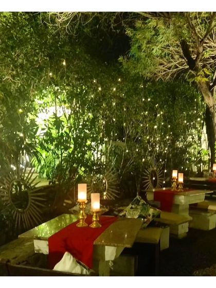 Another view of the candlelit tables against a backdrop of fairy lights. This reinforces the romantic and magical atmosphere we can create for evening celebrations.