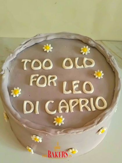 A fun and quirky cake for a 25th birthday! This "Too Old for Leo DiCaprio" cake is a great example of how we can bring your fun and humorous ideas to life. It's a simple, no-fondant cake that's sure to get a laugh.