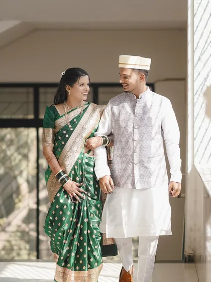 This couple is ready for their new beginning. The bride wears a classic engagement look with a green saree, complemented by makeup that highlights her features beautifully.