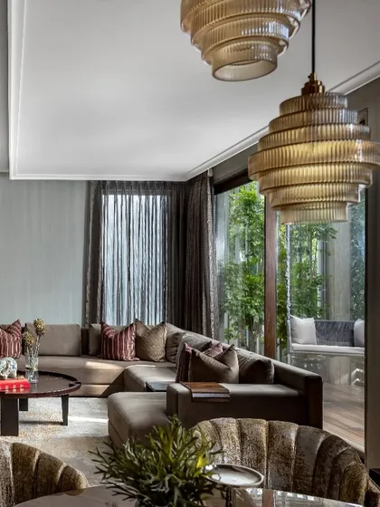 In the House of Two Worlds, we crafted intimate living spaces that are warm, light-filled, and personal. This view showcases the balance between luxurious comfort and a direct connection to the outdoors, a core principle in our residential architecture.