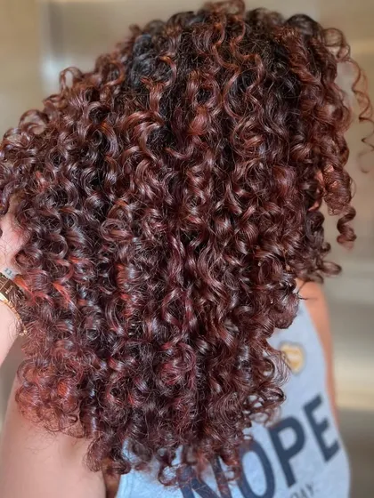 Another angle of the Pumpkin Spice curls, showcasing the beautiful blend of red and brown tones that give the hair a warm, autumnal feel.