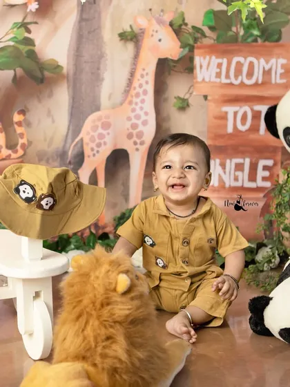Taking a break from exploring to share a happy laugh. The joy on his face is what these themed milestone sessions are all about.
