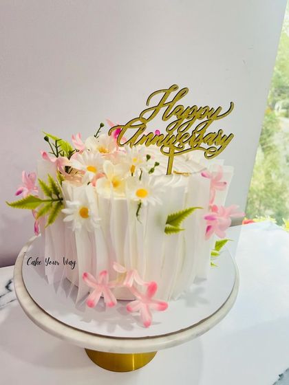Celebrating life’s sweetest moments with an elegant wafer paper and floral anniversary cake.