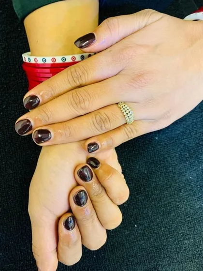 A deep, glossy maroon polish provides a classic and sophisticated look. This timeless color is perfect for any occasion, offering an air of elegance and refinement.