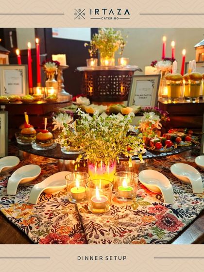 A beautiful dinner setup with a floral centerpiece and candles, creating a warm and inviting focal point for guests to gather around.
