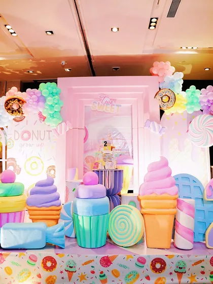 Another perspective of the Candyland stage, highlighting the layered backdrop and the arrangement of colorful, oversized sweet treat props.