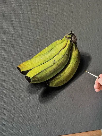 A realistic painting of a bunch of bananas. This piece, done with acrylics on canvas, was a study in how light interacts with the forms and colors of the fruit.