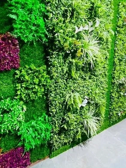 An example of a dense, textured artificial green wall. For areas with no sunlight or for clients who want a zero-maintenance option, I also design and install high-quality artificial vertical gardens.