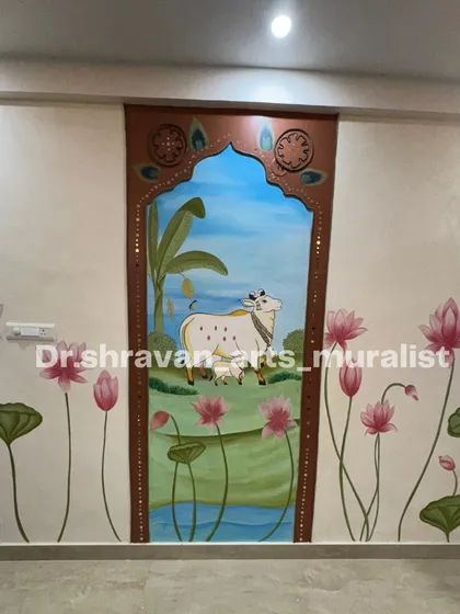 A closer look at the central framed portion of the Pichwai mural, highlighting the gentle expression of the cow and calf. The mirror work on the frame adds a subtle sparkle.