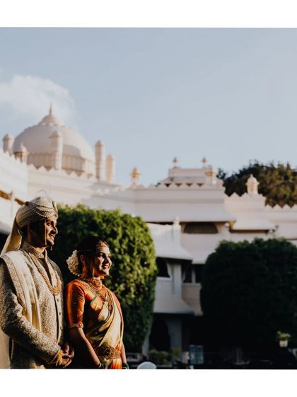 A beautiful shot of the couple against the backdrop of the majestic Taj Vivanta, capturing the grandeur of their wedding location.