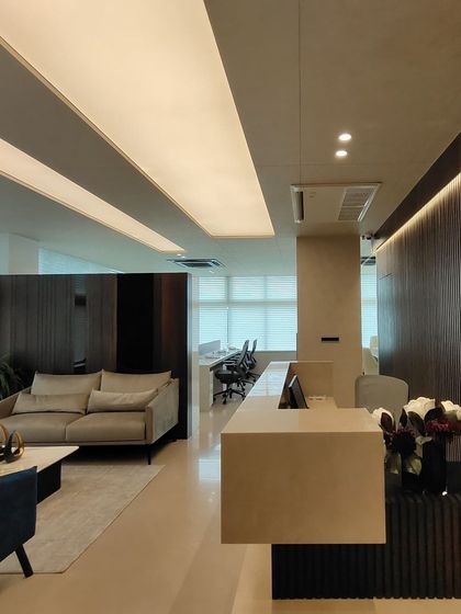 A wider perspective of the reception and open-plan office area at the RS head office. The layout is designed for a seamless flow between the public-facing reception and the private workspace, maintaining a consistent modern design language.