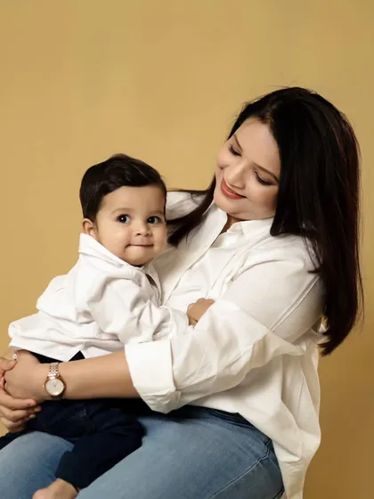 A beautiful, tender moment between a mother and her son. The simple background keeps the focus on their loving gaze and connection.