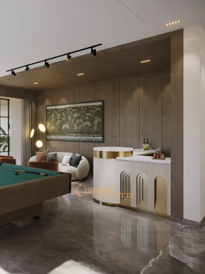 The custom-designed bar with its curved form and gold accents serves as a stylish focal point in this entertainment lounge.