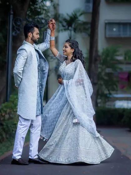 A playful moment as the couple shares a dance during their outdoor engagement photoshoot.
