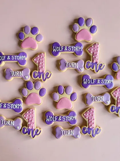I love creating custom party favours like these for birthdays. This set for Wolf and Storm's first birthday includes personalised bone-shaped biscuits and paw-print cookies, all decorated by hand.
