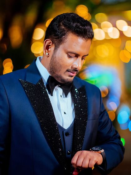 A classic portrait of the groom at the reception, with beautiful bokeh from the evening lights.