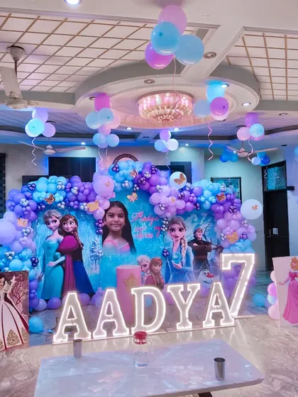 A wider view of the hall for the Frozen-themed 7th birthday party, showing how the setup transforms the entire space.