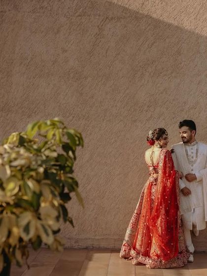 A minimalist portrait of the couple against a simple wall, the natural light creating beautiful shadows.
