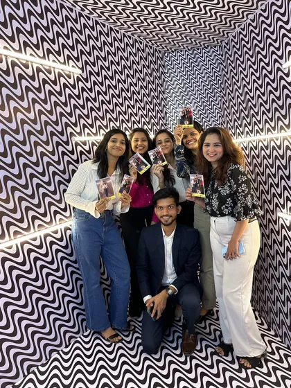 A group of smiling faces holding up their instant prints from our Magic Mirror booth. There's nothing better than seeing guests immediately enjoy their tangible memories.