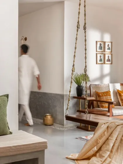 The open layout allows for fluid movement through the space. A high skirting in grey IPS unifies the living and dining areas, creating a seamless transition.